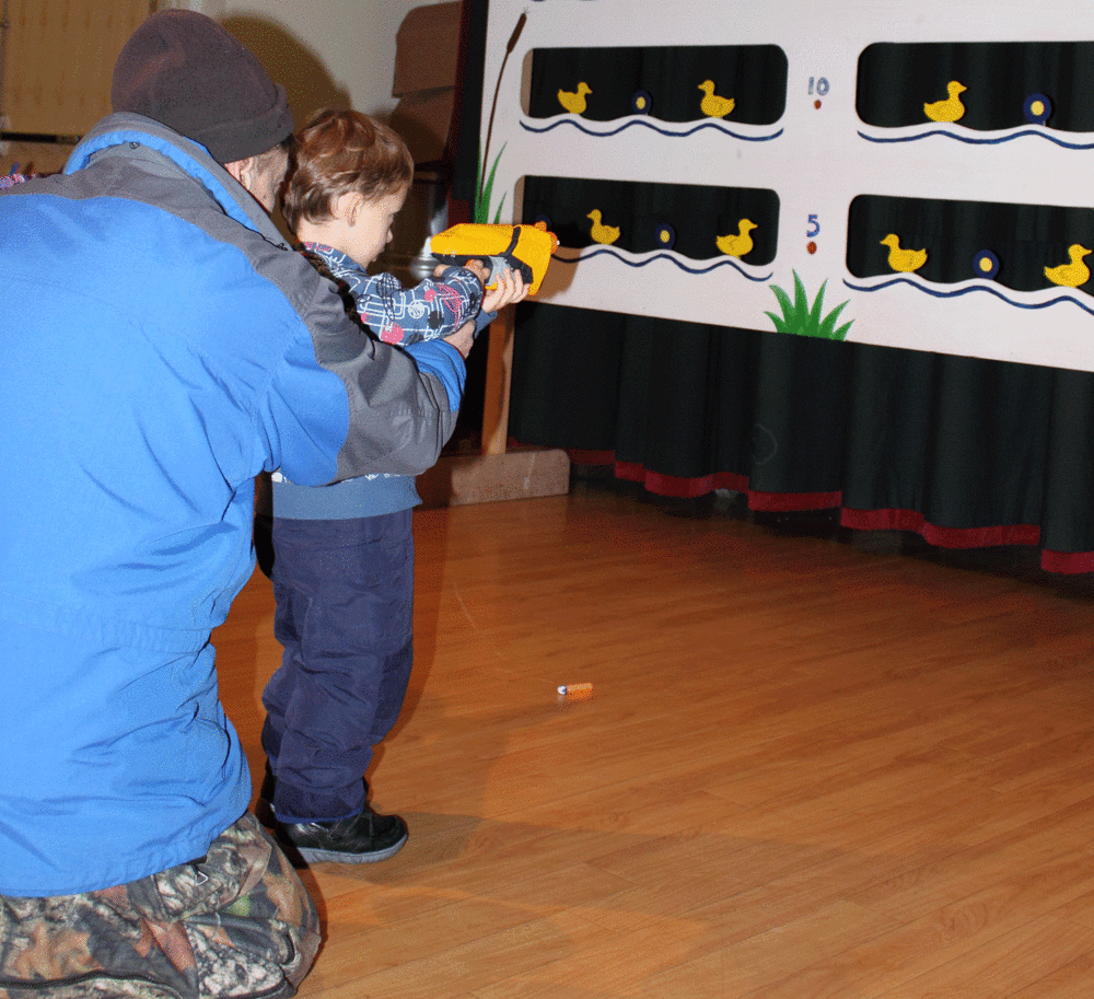  Dad helping his son with the proper shooting stance. 