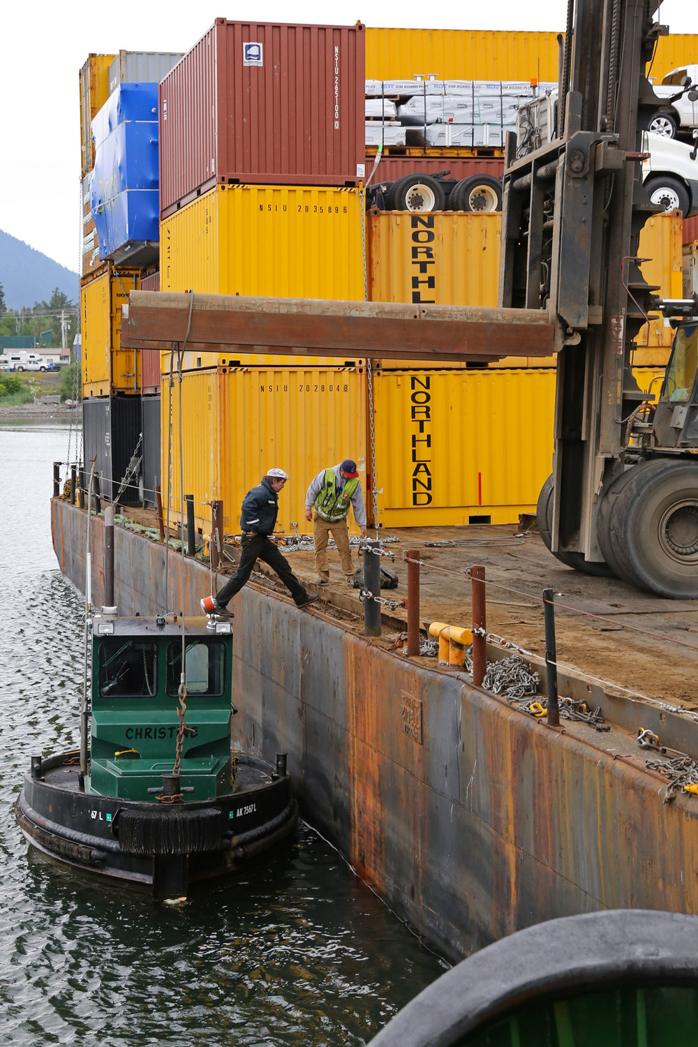 Stepping onto the barge after hooking up the lift gear. 