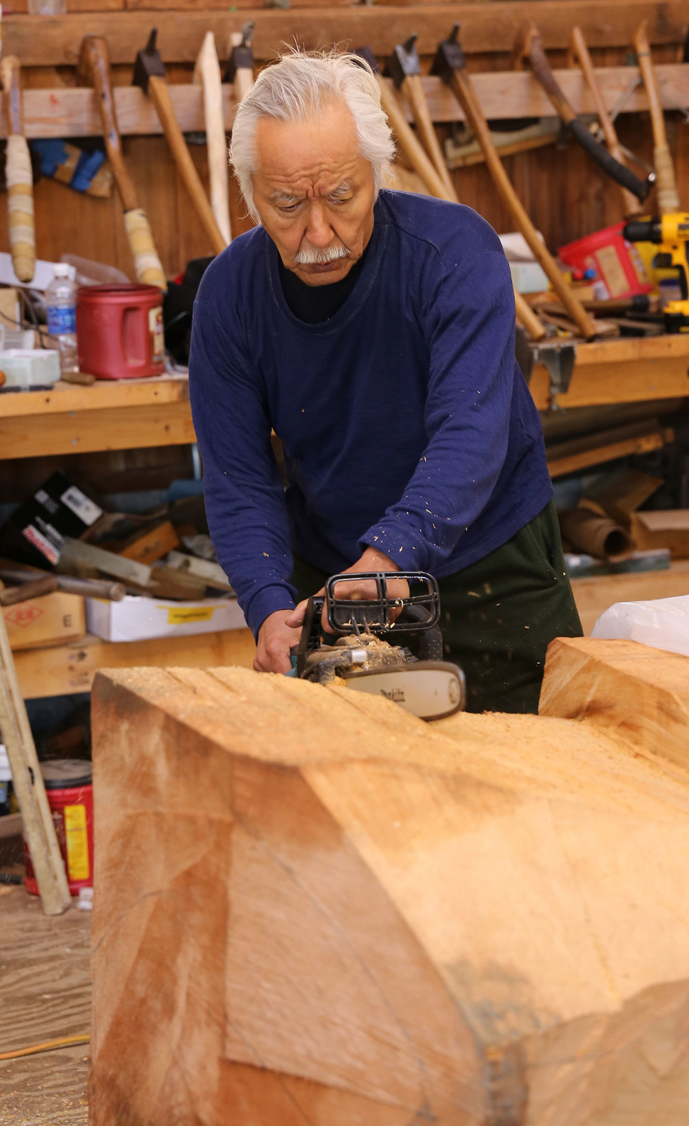 Nathan Jackson makes sure cuts with the chainsaw.