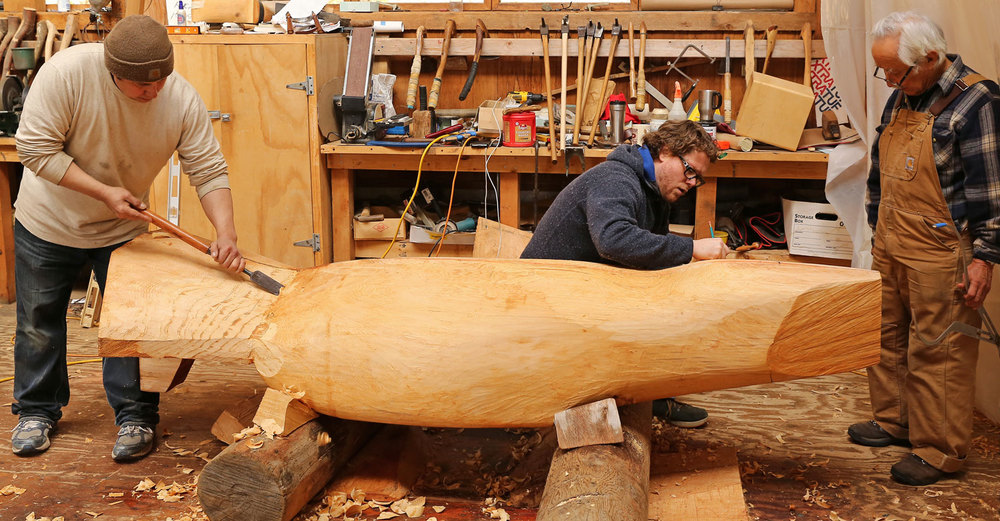 John Hughes carves with a slick while Donald Varnell and Nathan Jackson make marks to note adjustments.