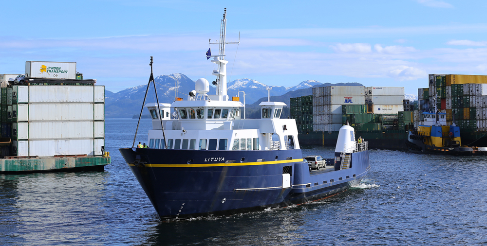 The 181 foot (55 meter) Lituya maneuvering between two freight barges to dock in Ketchikan. She runs from Metlakatla to Ketchikan, and then back the Metlakatla, each day.