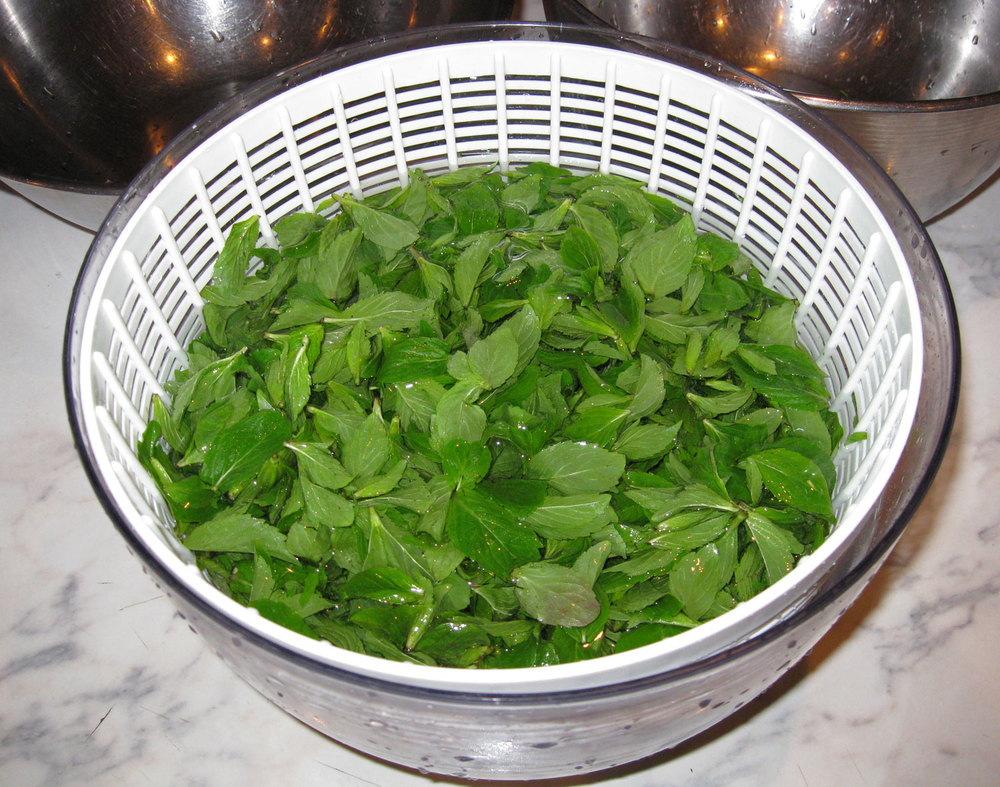 Rinsing in a salad spinner is nice because the leaves can be lifted out in the colander and the grit stays in the bowl.