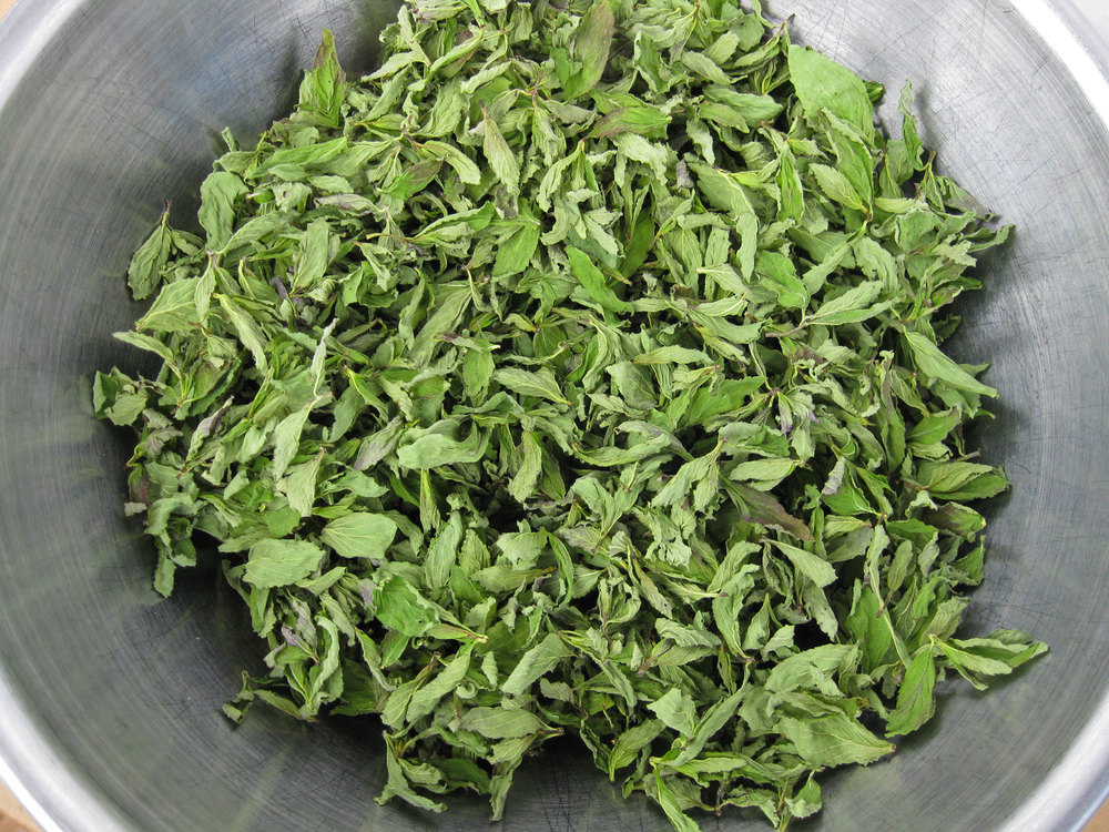 If the mint is handled well and dried quickly then it will retain some of the green color.