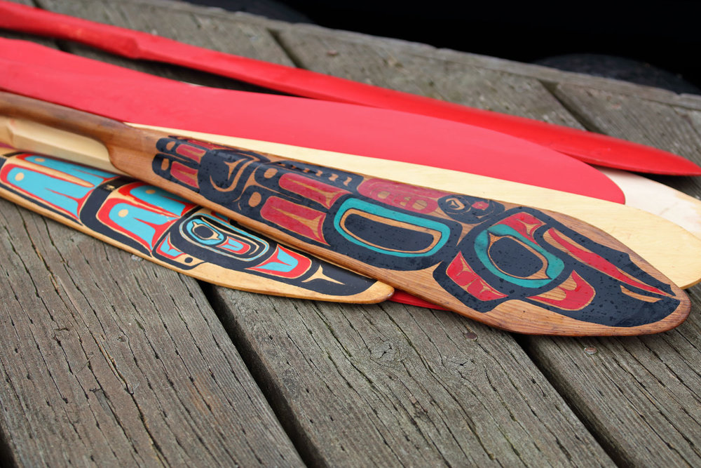 Hand painted canoe paddles on the dock at the harbor.