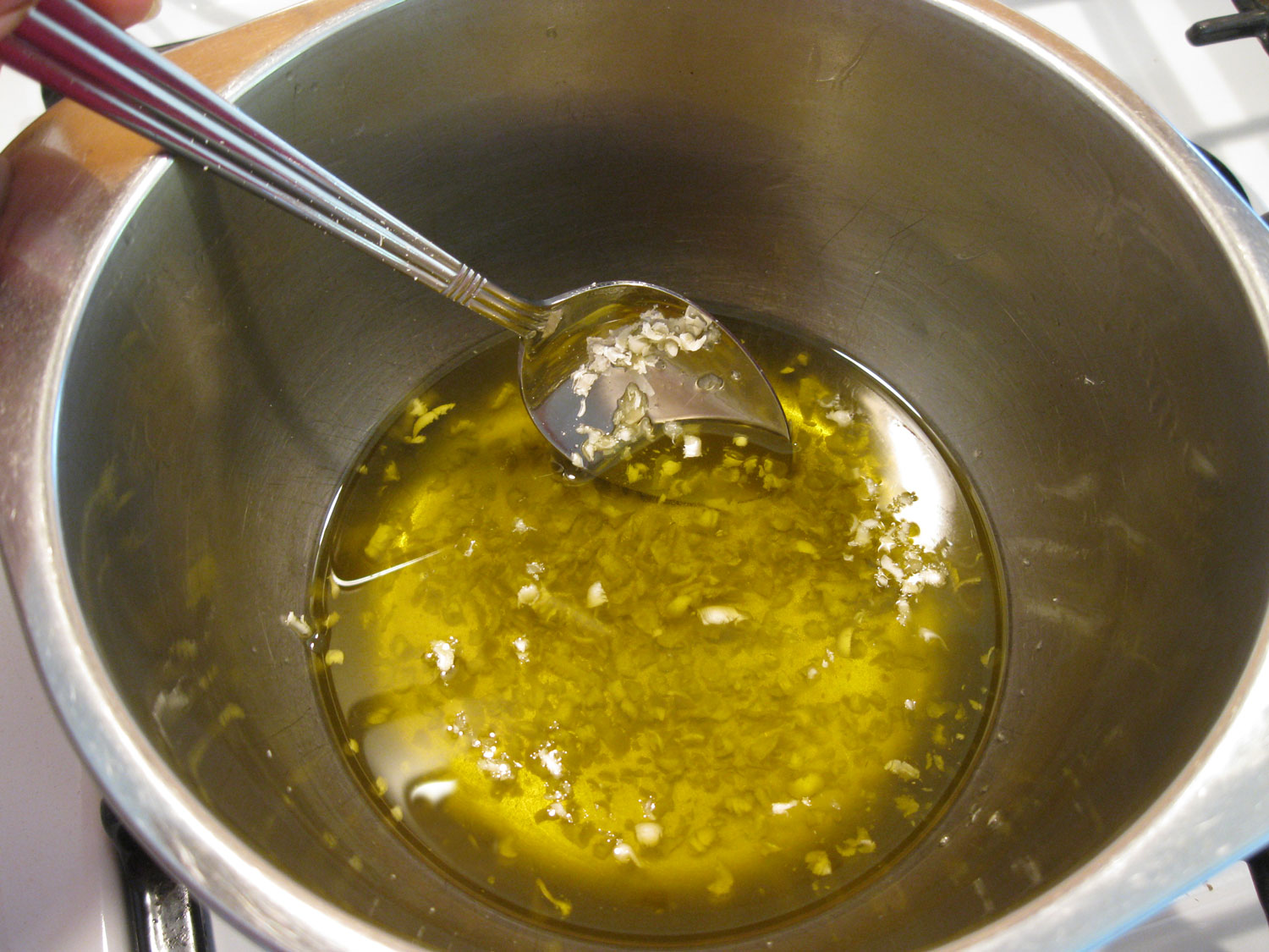 Stirring beeswax into the devil's club infused oil.