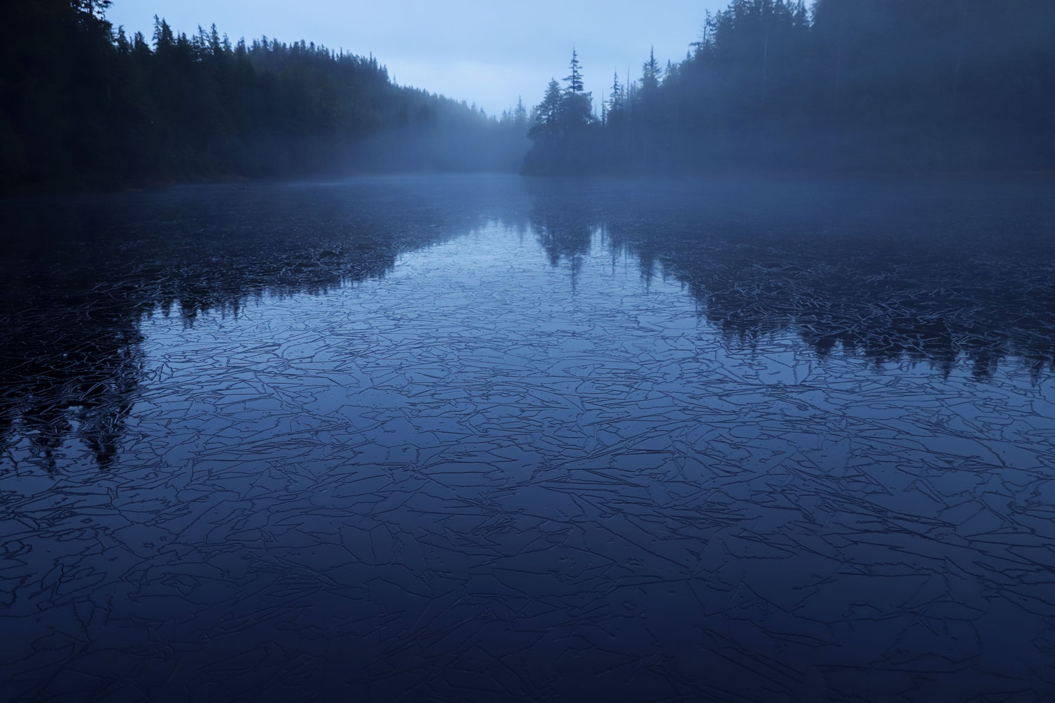 Lake with crazed ice and mist