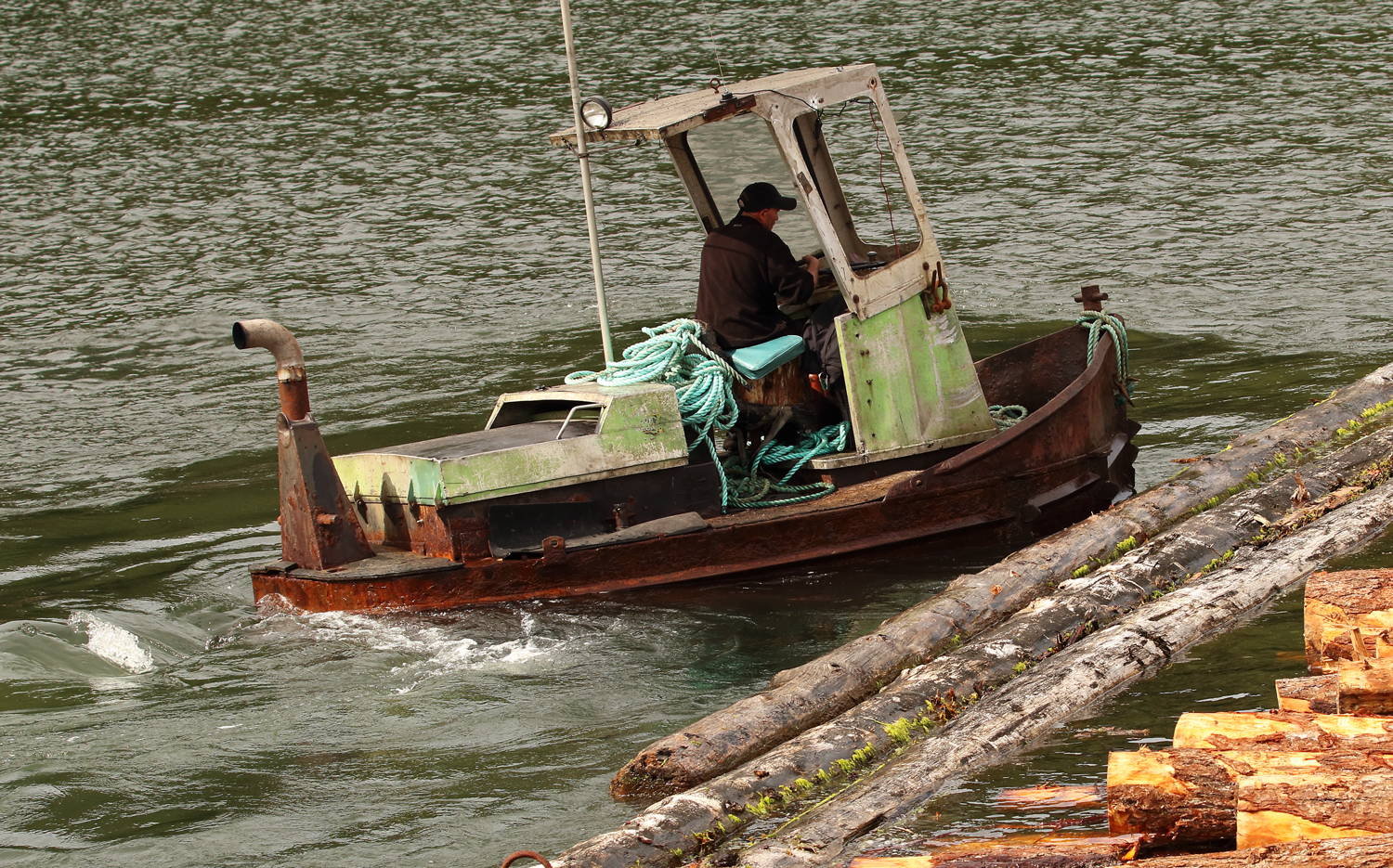 Log bronc boom boat working boom sticks by Prince of Wales Island in Southeast Alaska