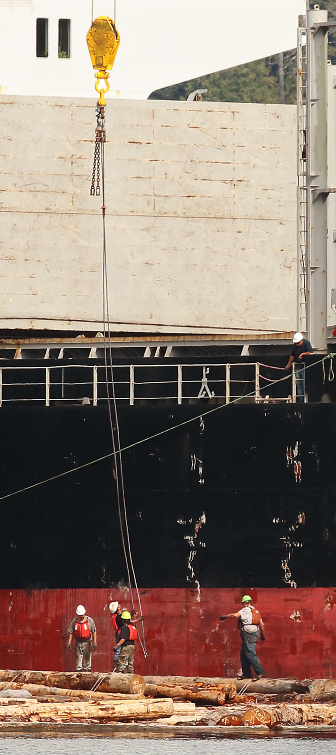 Log ship lowering cable to hook up log bundles Prince of Wales Island Southeast Alaska