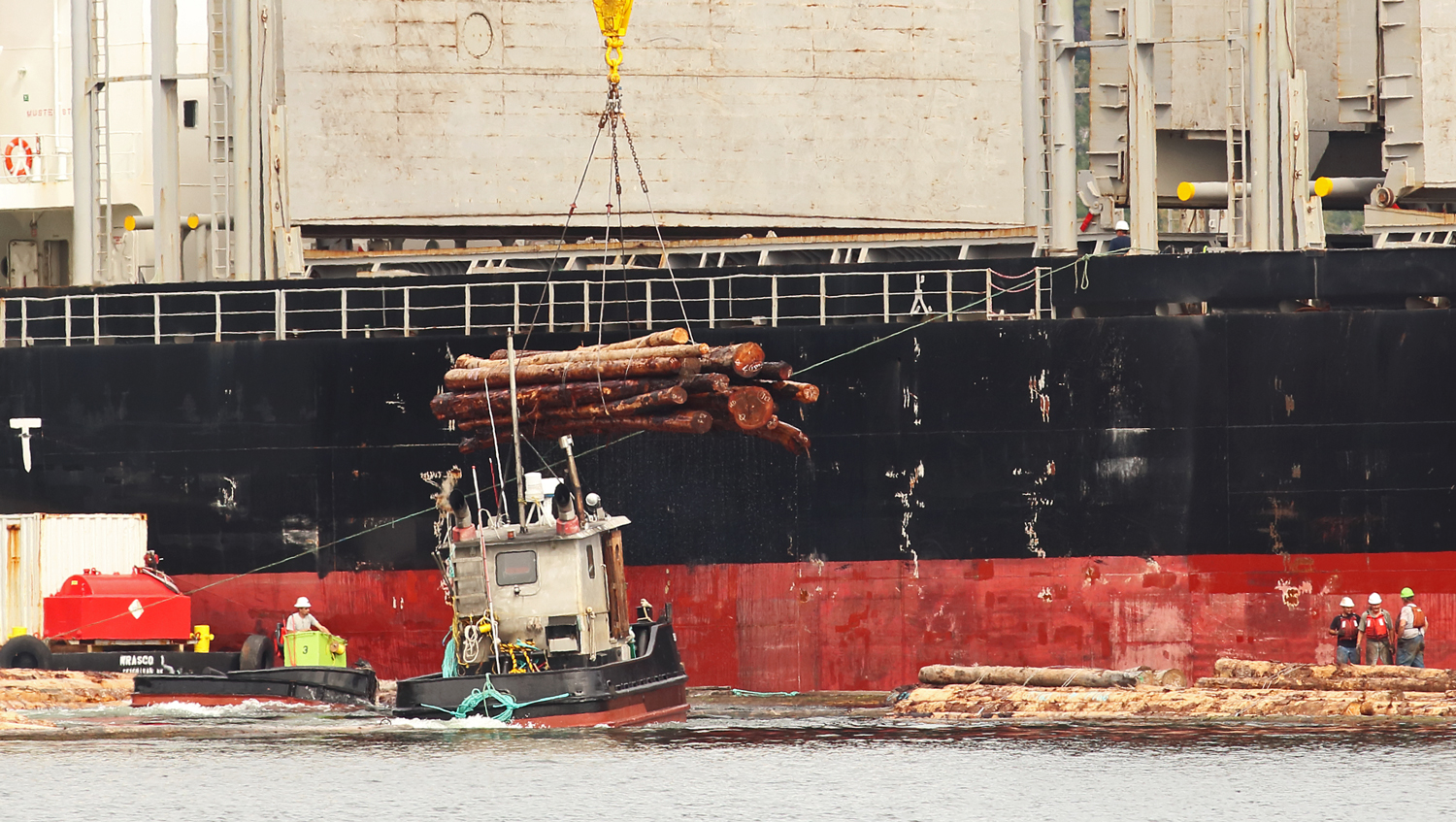 Tug Sophia C and boom boat working at log ship loading Prince of Wales Island Southeast Alaska