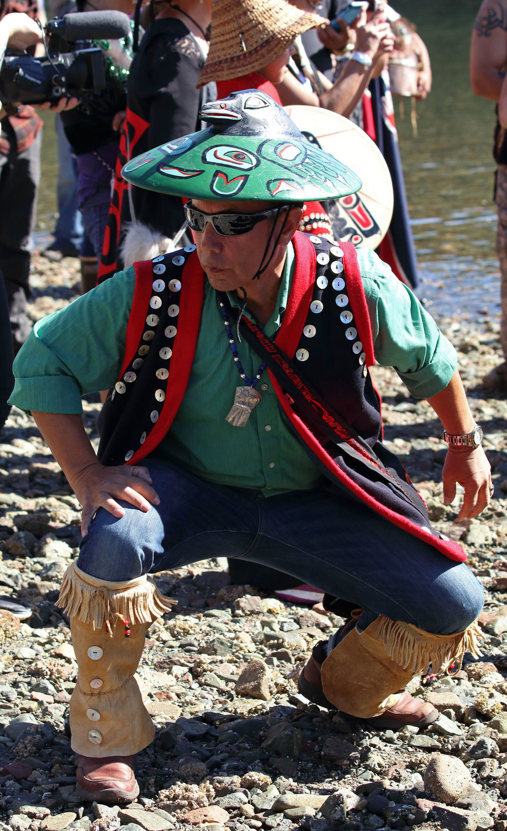 A dancer on the beach enjoyed the singing and drumming.