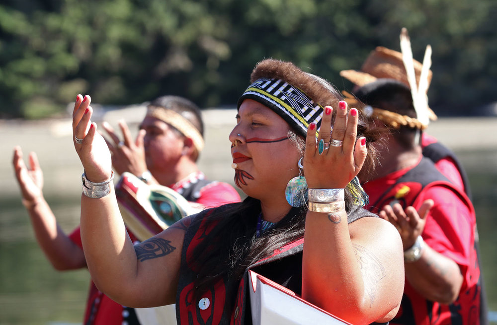 Dancers standing by their canoes during the ceremony.