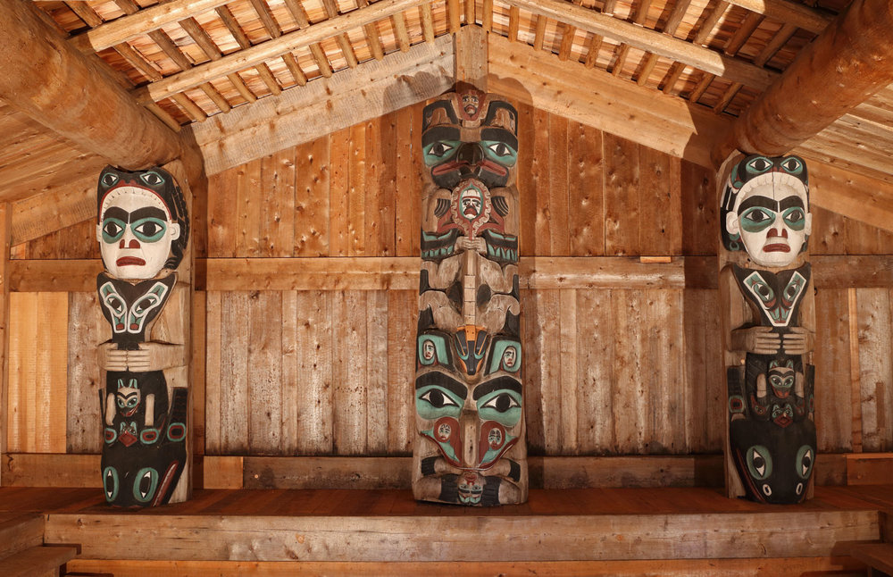 Inside the Whale House there are three totem poles that tell Haida stories.